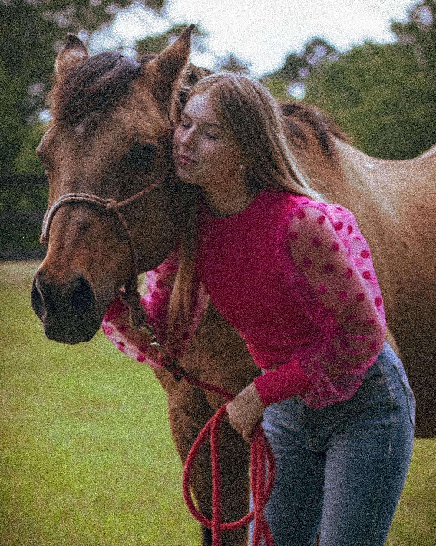 A girl leading her horse in from the pasture