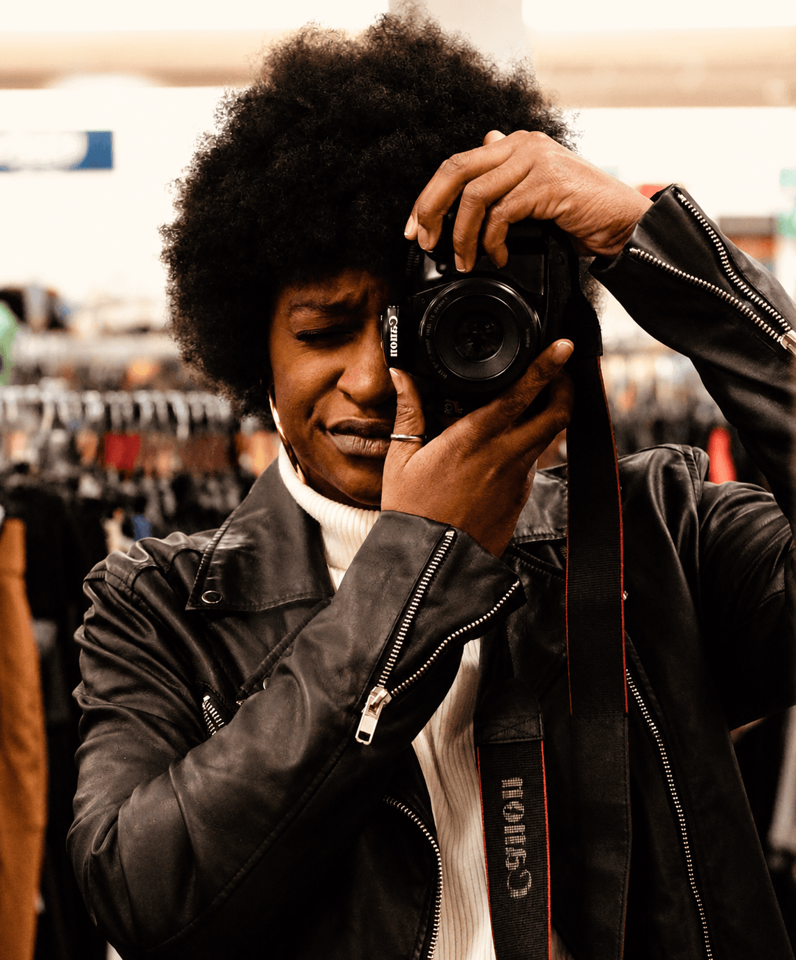 Telondra Reynolds holding her camera, turned toward the light